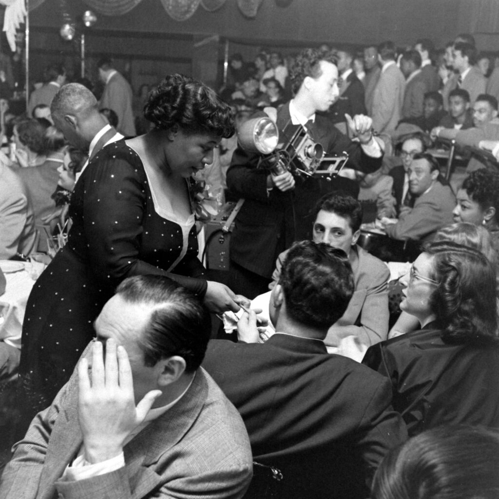 Ella Fitzgerald mingled with people who had come to hear her perform at the opening night of the Bop City nightclub in New York City, April 1949.