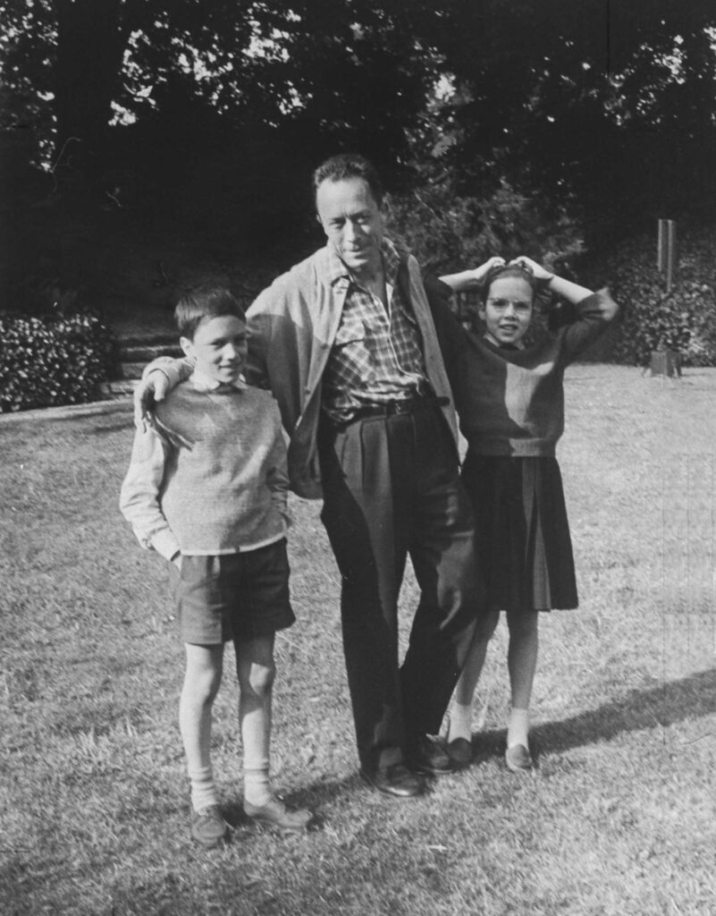 French author Albert Camus poised at home with his 11-year-old twins Jean and Catherine, 1957.